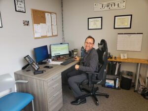 man sitting at a desk in an office at the Grand Opening of the new Bridge Back To Life Center facility in Bethpage, New York