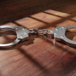 pair of handcuffs on a wood table