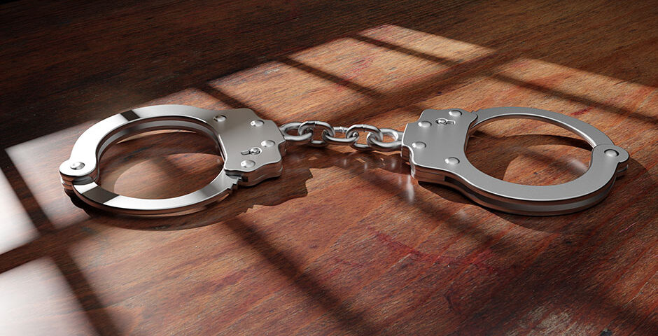 pair of handcuffs on a wood table